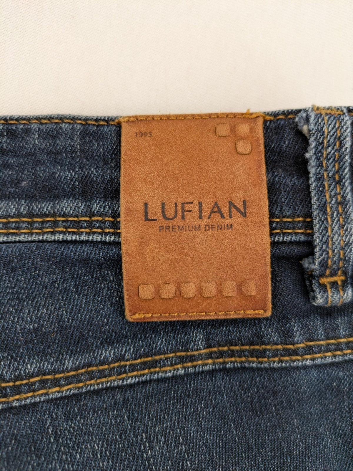 Lufian blue straight jeans dark wash distressed 5-pocket style with stretch denim.