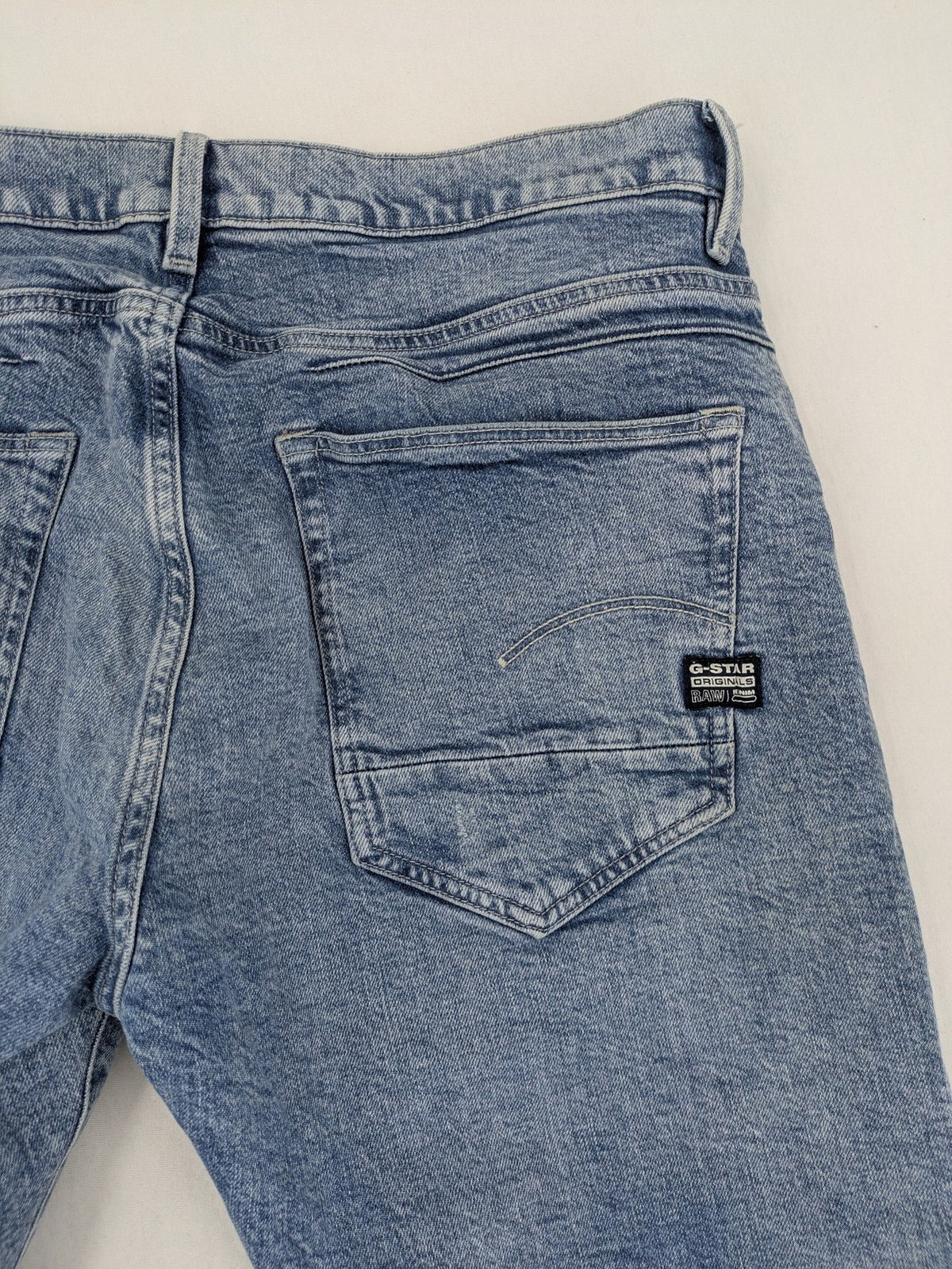 G-Star Raw blue slim fit jeans with 5-pocket design and light wash denim.