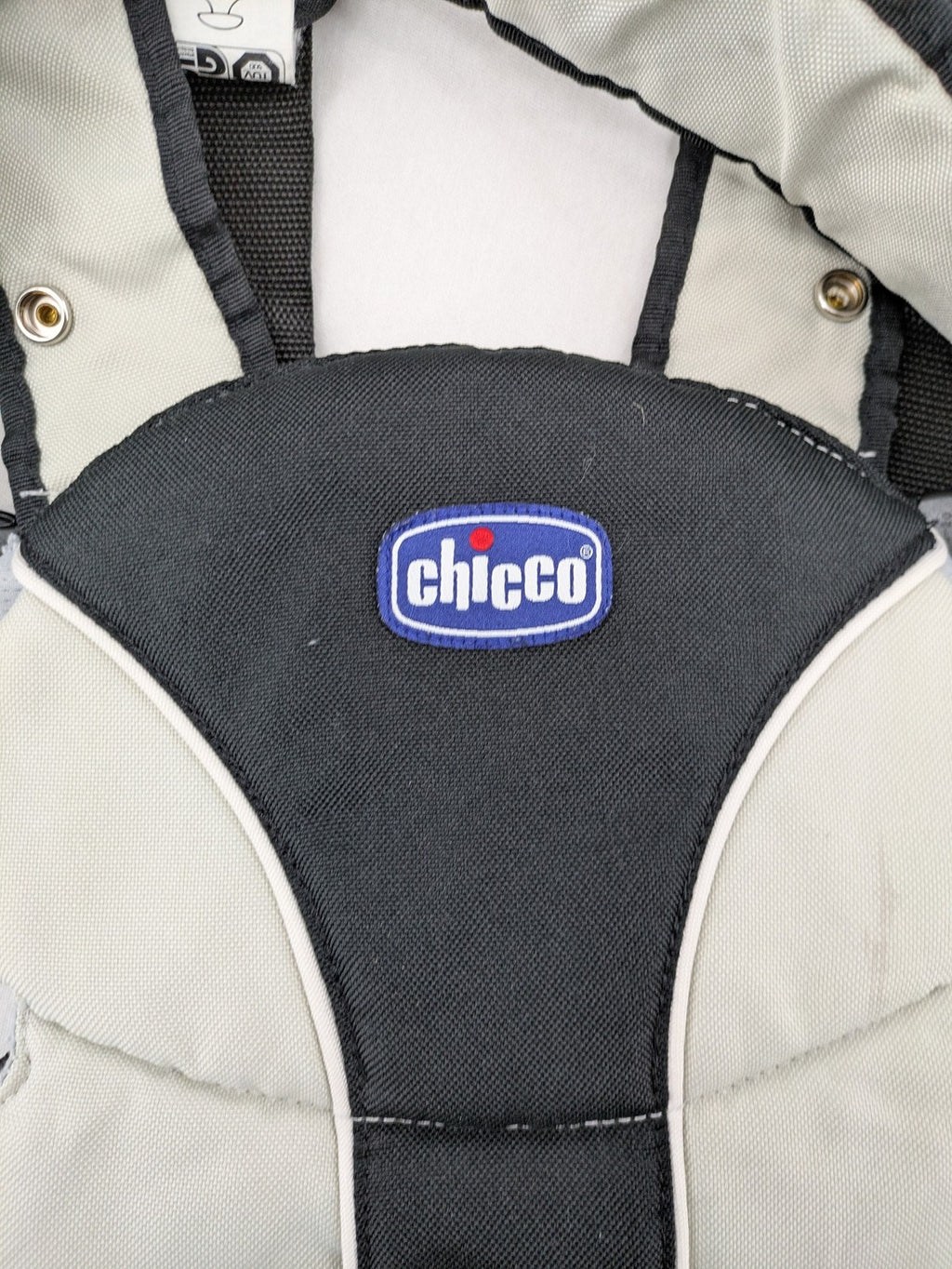 Chicco beige and black baby carrier adjustable straps with padded support for comfort.