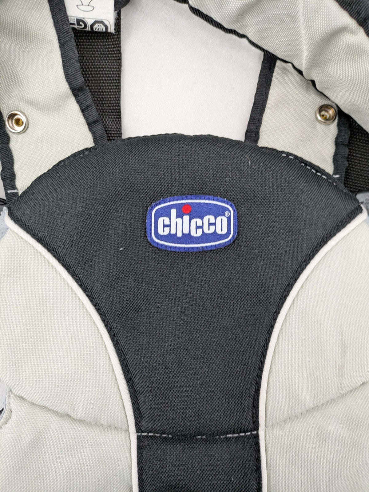 Chicco beige and black baby carrier adjustable straps with padded support for comfort.