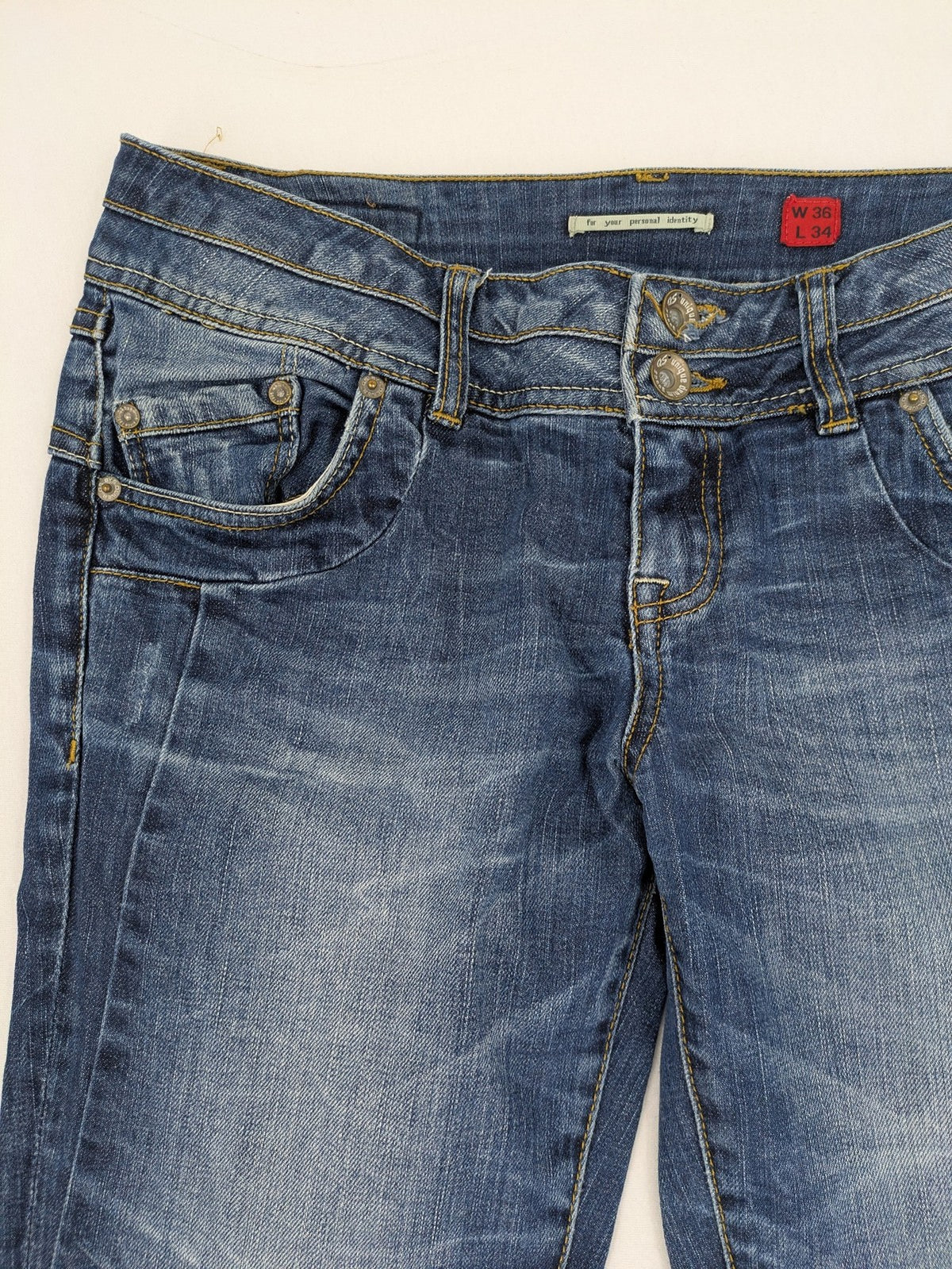 QS by s.Oliver green straight jeans five-pocket design with unique double button closure