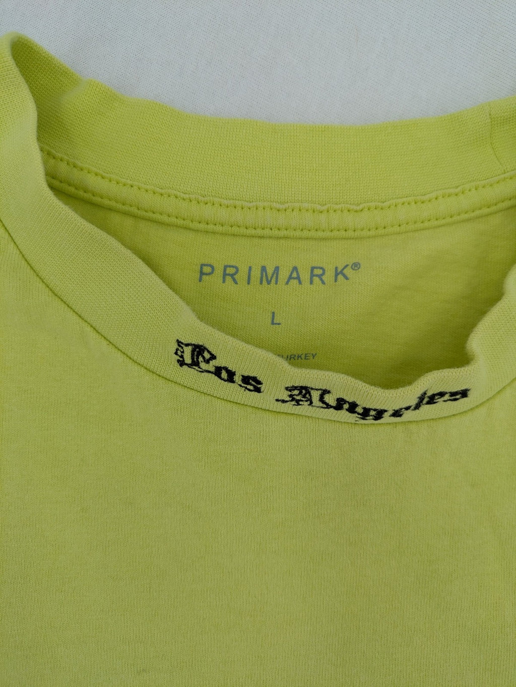 Primark yellow band t-shirt featuring Gothic LA graphic print and "PRESENT" patch.