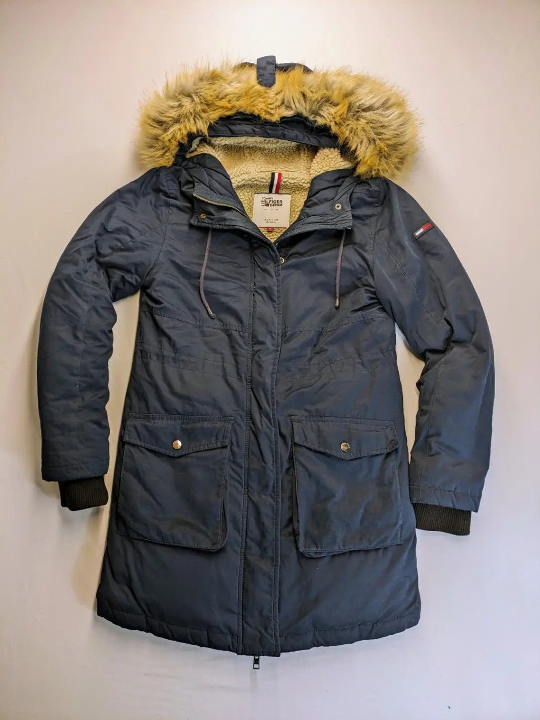Tommy Hilfiger Denim blue parka coat with faux fur hood and Sherpa lining.