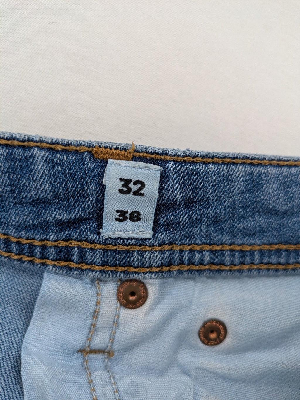 Jack & Jones blue slim jeans with button fly and subtle used look.