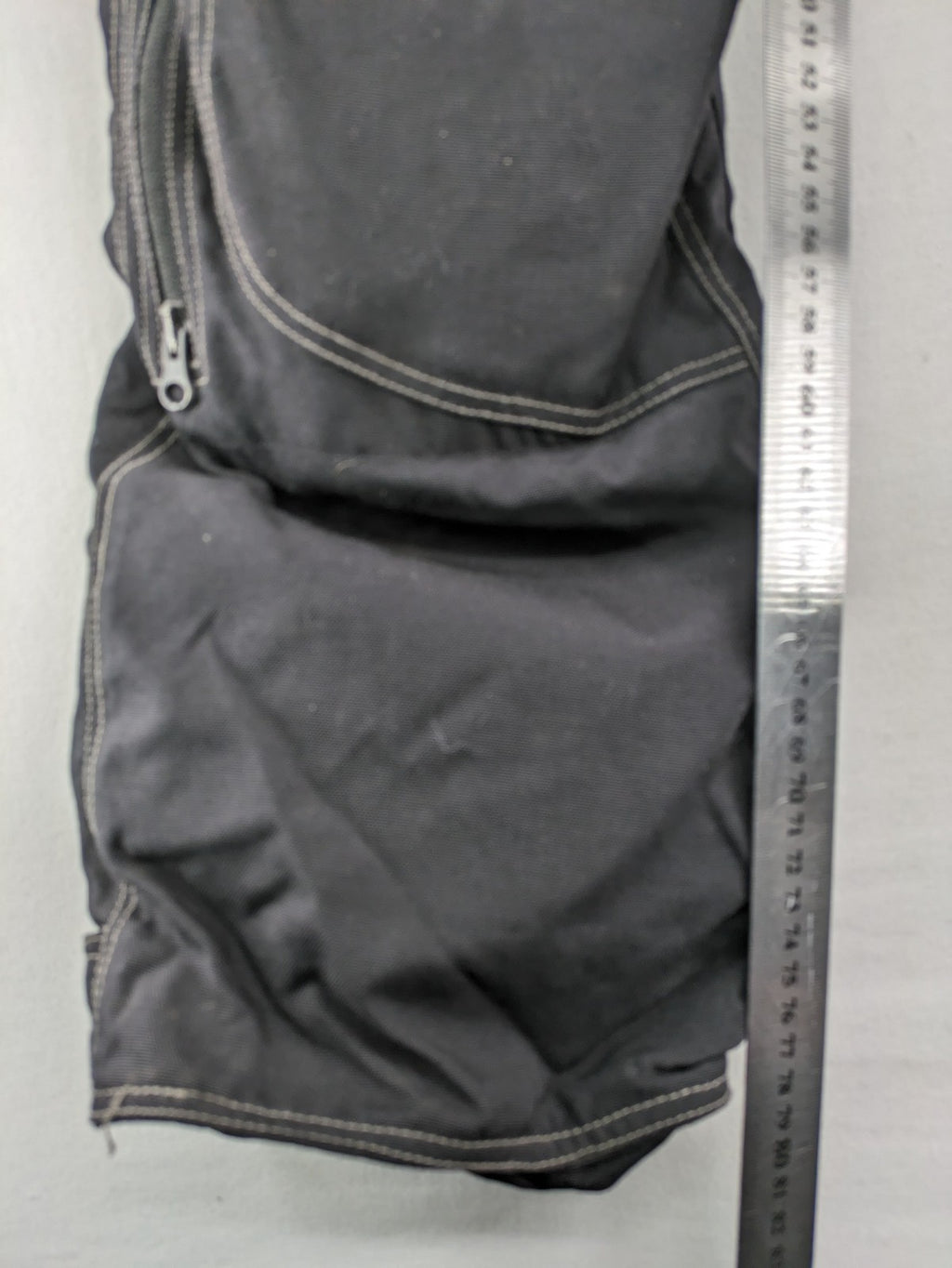 Rukka black motorcycle chaps with grey accents and CE knee protectors, made from durable Cordura.
