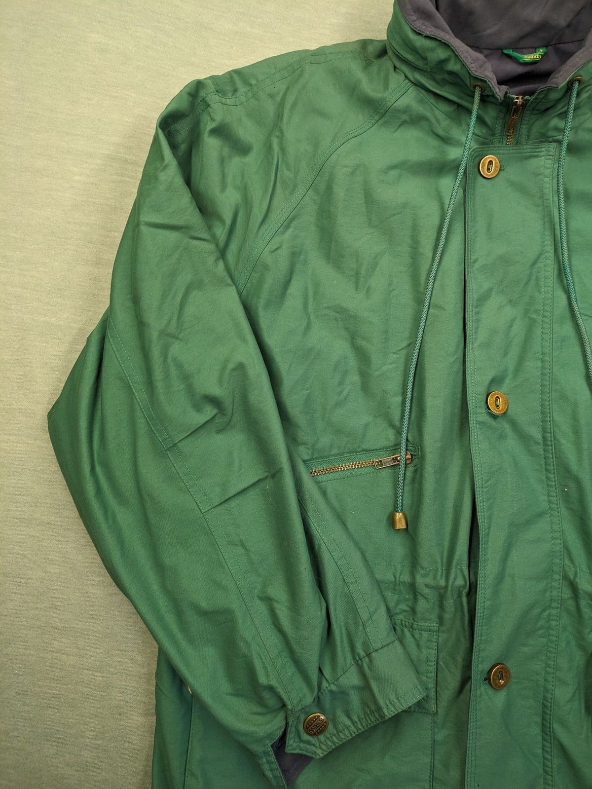 Canda green parka coat with dark lining, multiple pockets, and Micro Membrane technology.