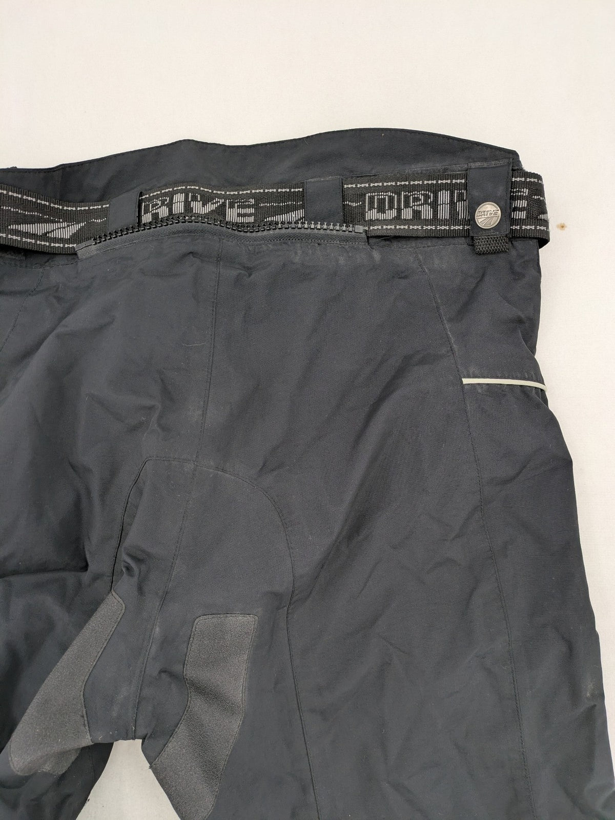 Polo black chaps with grey and white accents, featuring protective knee pads and adjustable belt.
