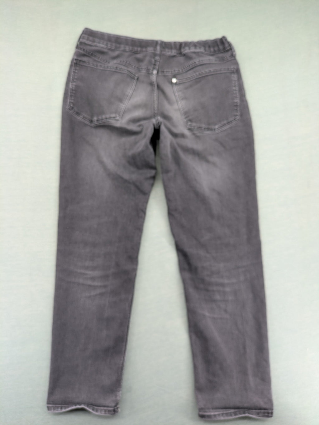H&M grey slim fit jeans with adjustable waistband and faded wash detail.