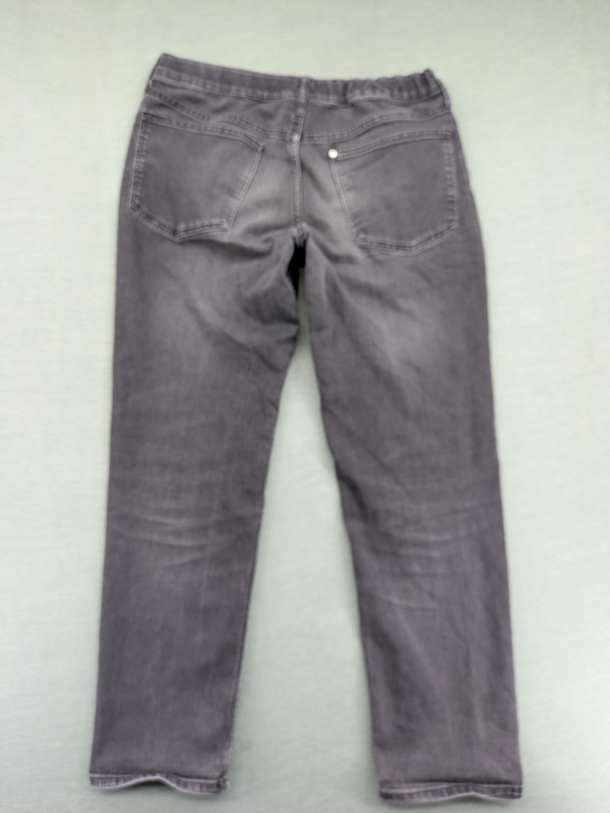 H&M grey slim fit jeans with adjustable waistband and faded wash detail.