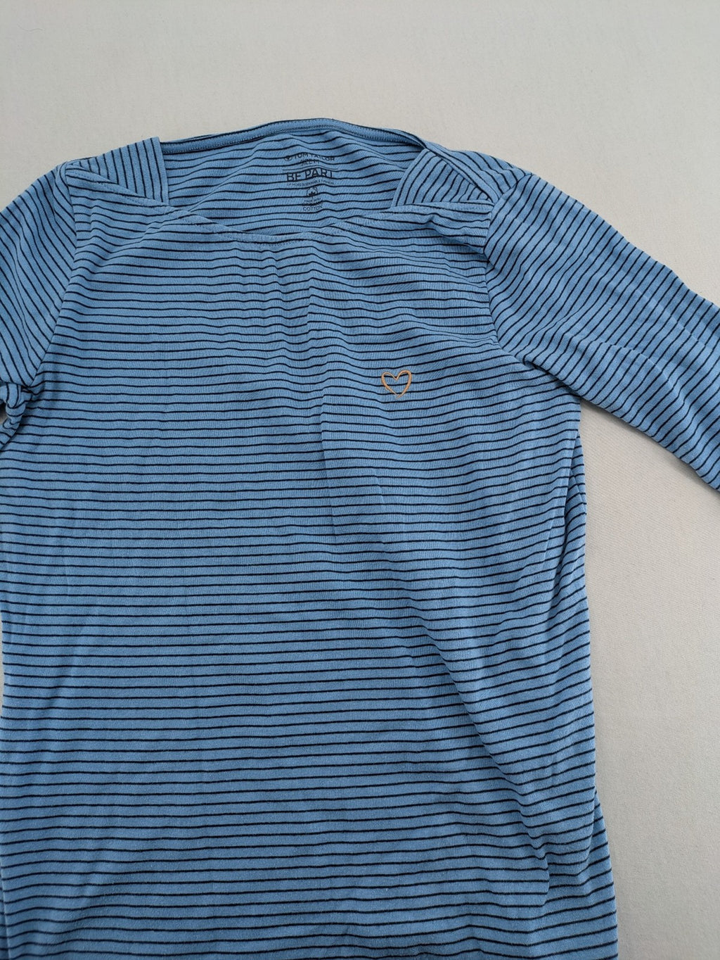 Tom Tailor blue striped top with gold heart emblem, made from organic cotton.