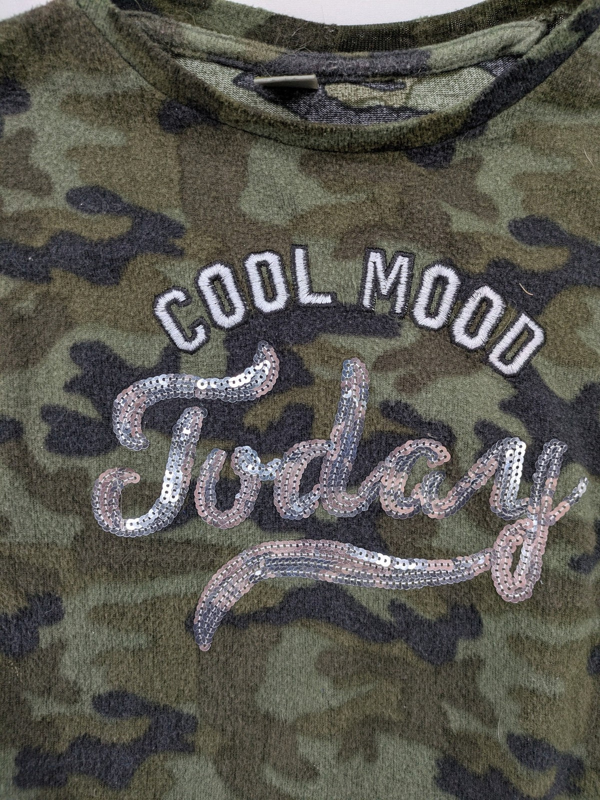 YFK turtle neck jumper multi camouflage print with sequined "COOL MOOD Today" graphic.