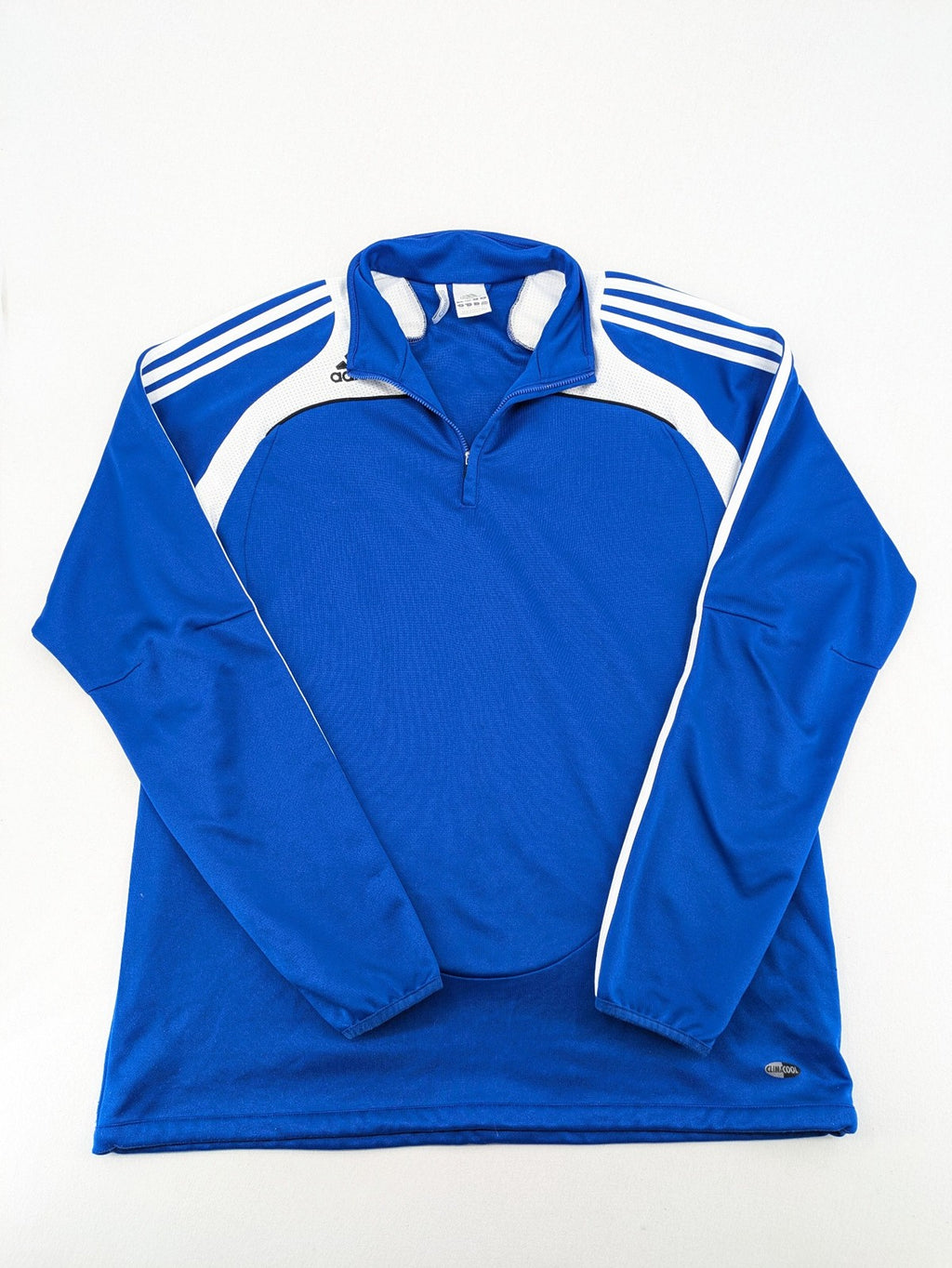 Adidas blue long sleeve top with white three stripes and 1/4 zip collar.