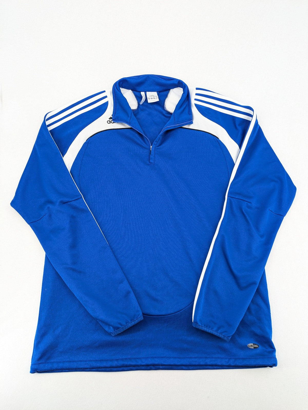 Adidas blue long sleeve top with white three stripes and 1/4 zip collar.