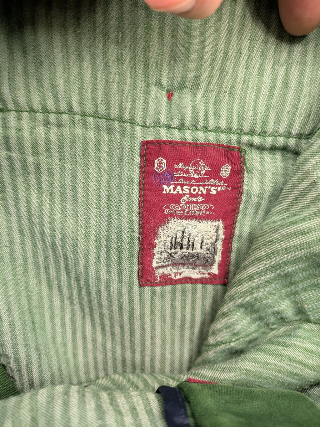 Mason's green chino pants with striped red and blue waistband, cotton stretch material.