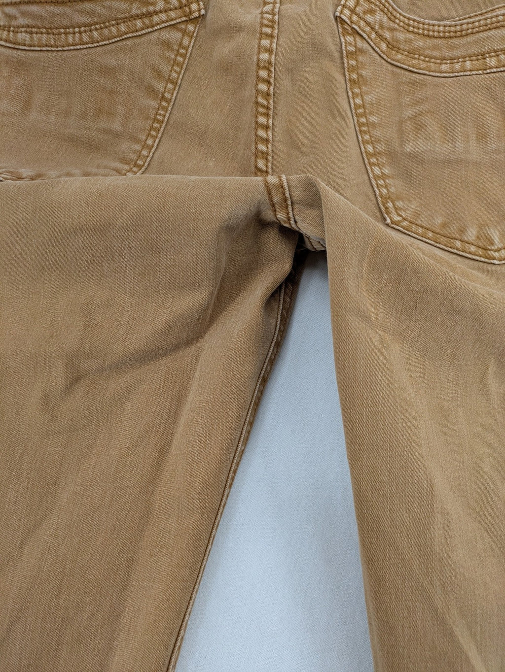 Buena Vista beige capri jeans with frayed hem and button fly detail.