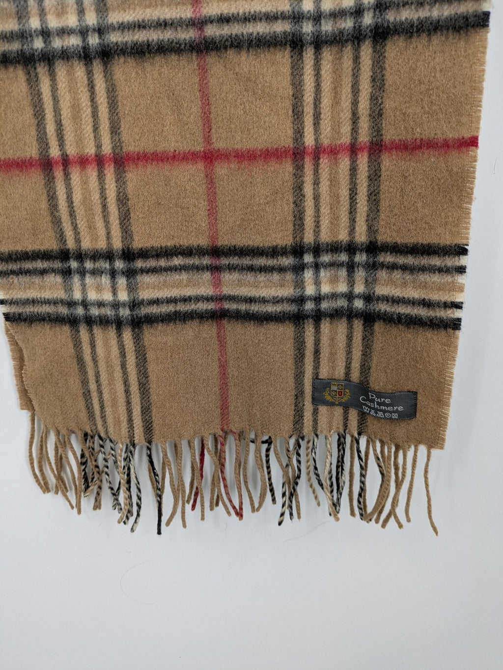 Karo unisex scarf camel brown tartan pattern 100% cashmere with black, white, and red accents.