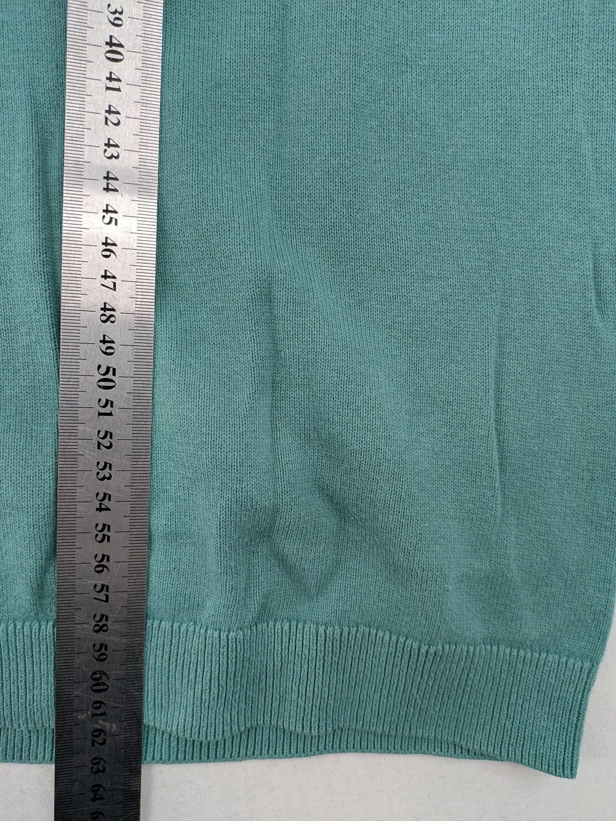 BESTies green turtle neck jumper with white skateboard graphic and ribbed cuffs.