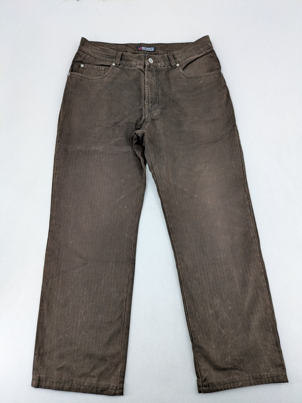 Authentic Clothing Company brown straight jeans with subtle stripe pattern and brand patch.