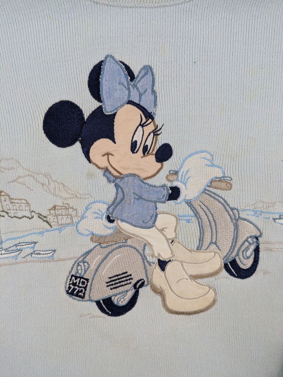 Donaldson multi turtle neck jumper light blue with embroidered Minnie Mouse graphic and ribbed texture.