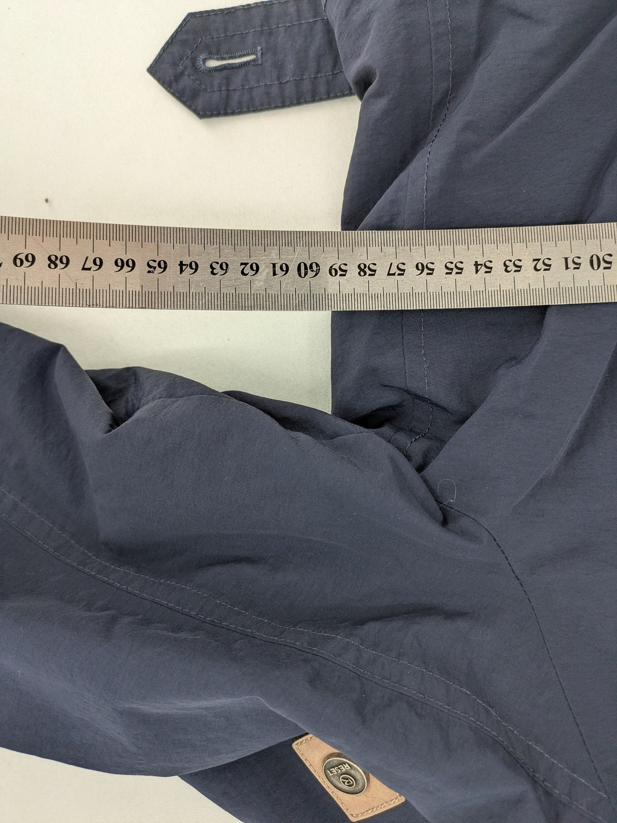 Reset navy parka jacket windproof with adjustable hood and zippered chest pocket.