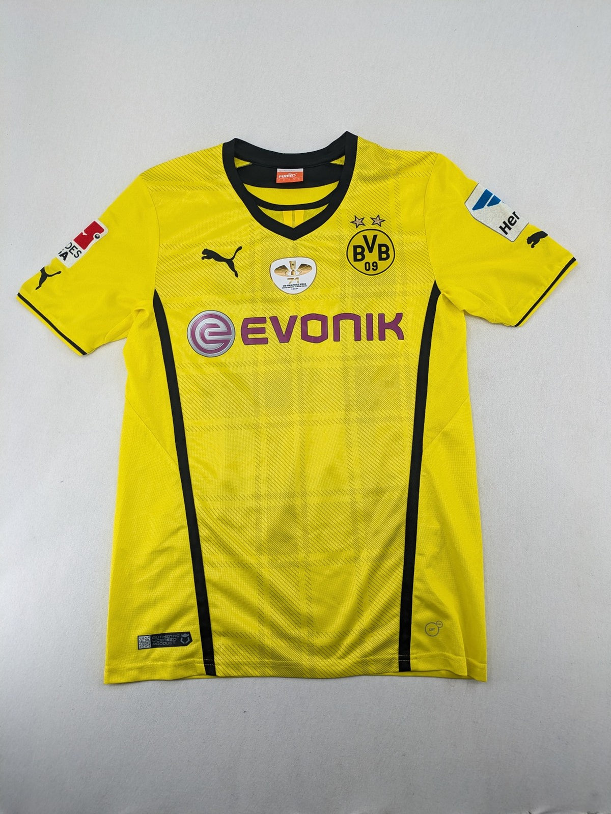 Borussia Dortmund black and yellow soccer uniform with DFB Pokal 2014 patch and Puma logo.