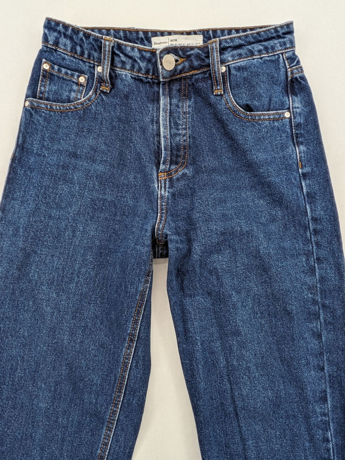 Stradivarius blue mom jeans high waist with button fly and classic denim texture.