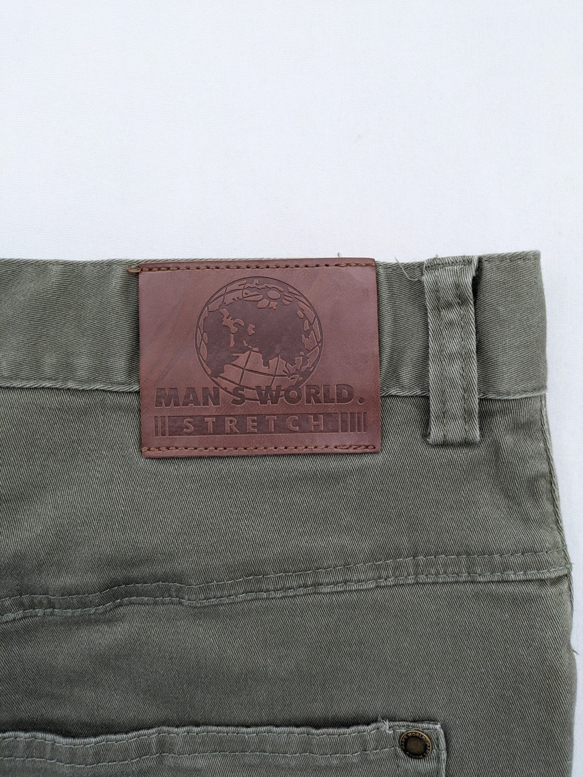 Man's World khaki chino pants with button and zipper closure, made from cotton-elastane blend.