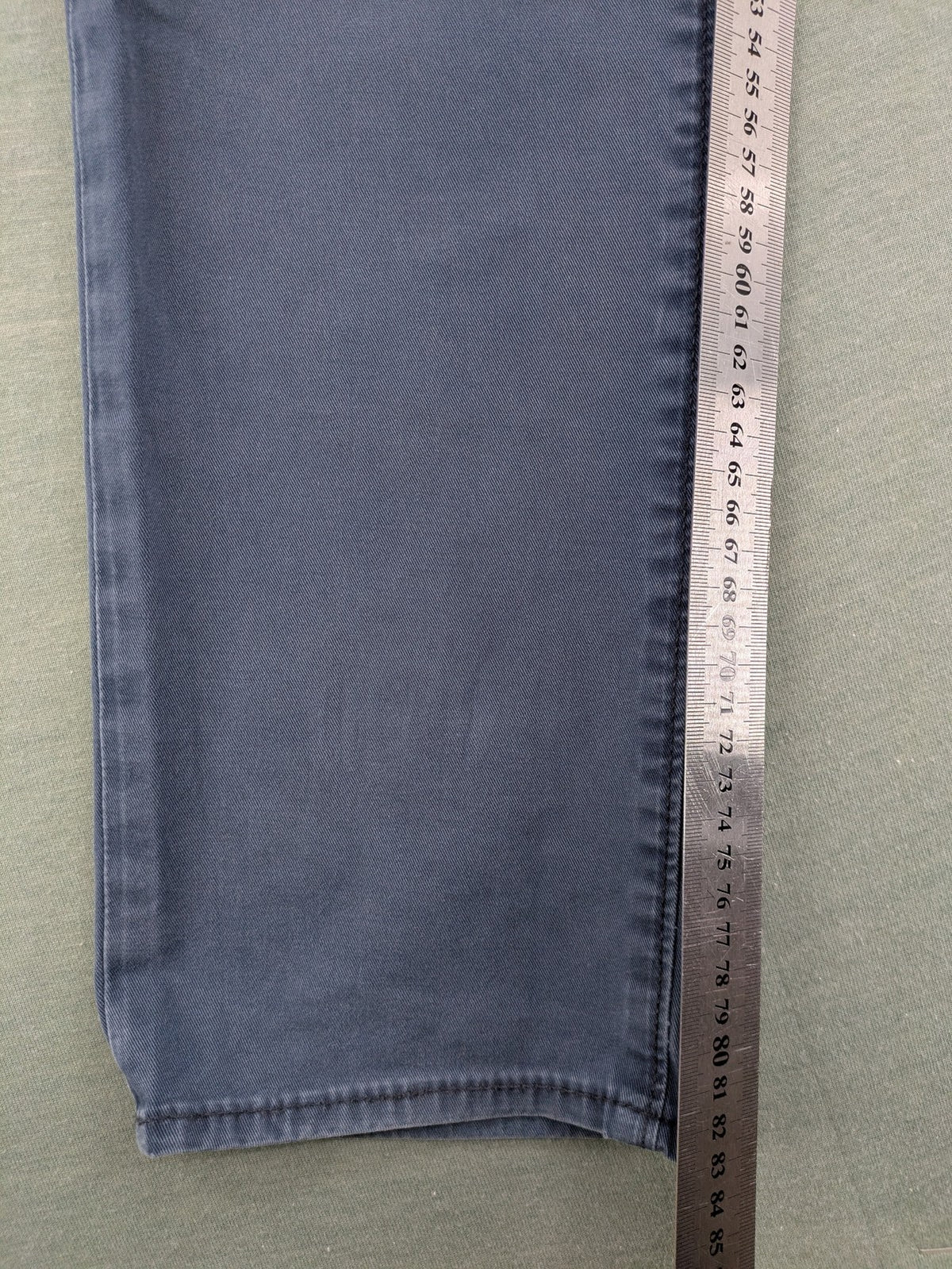 Levi's blue slim fit jeans with faded wash and classic 5-pocket design.