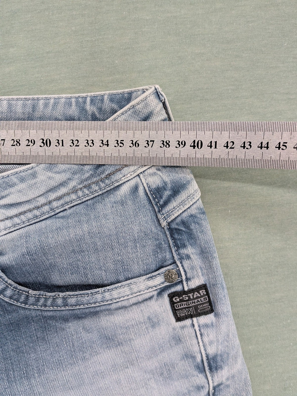 G-Star Raw blue straight leg jeans with classic 5-pocket design and light wash denim.