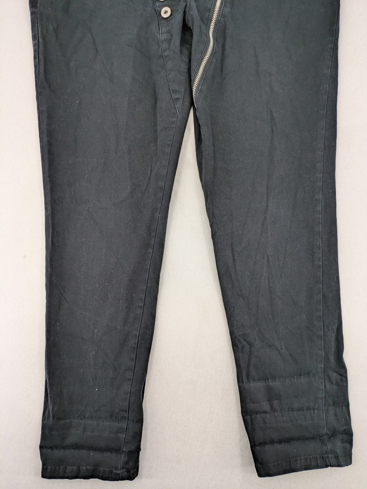 REI grey pants asymmetrical design with diagonal zipper and button placket, cotton blend.