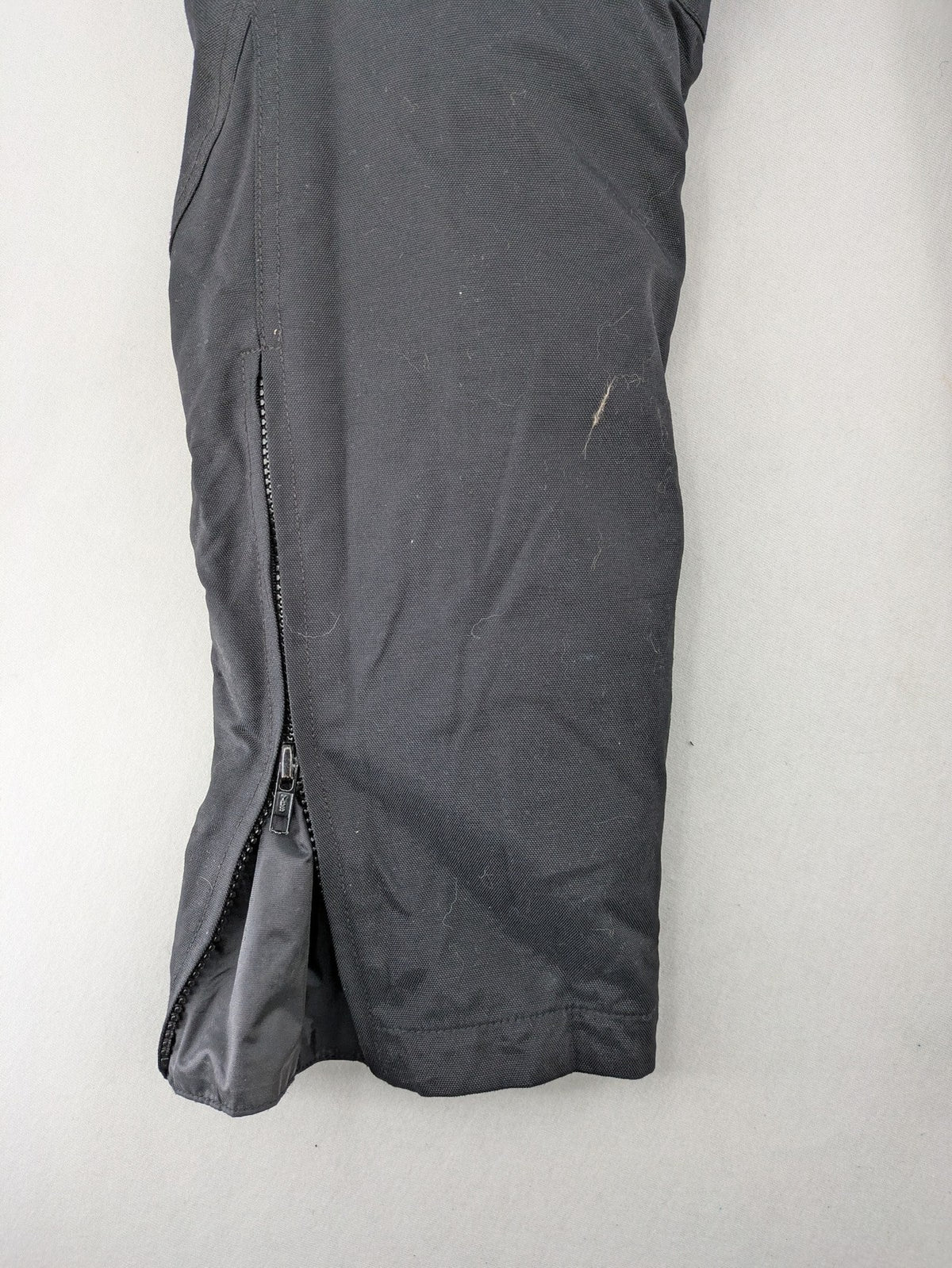 iXS black chaps with grey accents, waterproof textile, adjustable belt, reinforced knees.