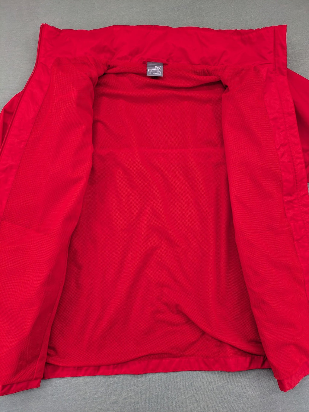 Puma red windbreaker jacket full zip with iconic logo and breathable mesh lining.