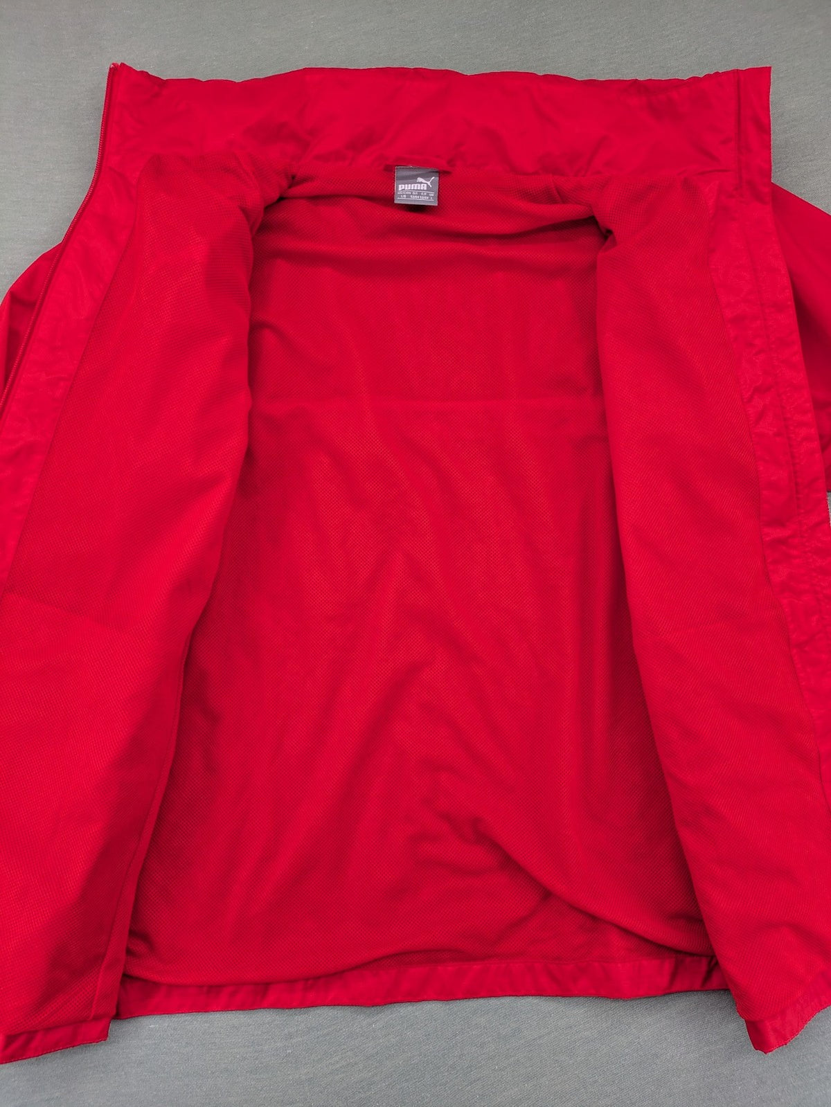 Puma red windbreaker jacket full zip with iconic logo and breathable mesh lining.