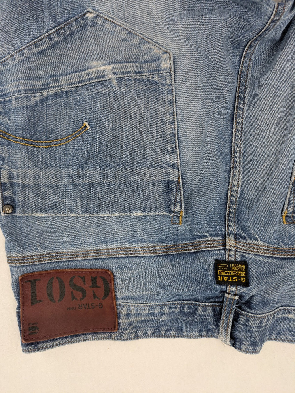 G-Star Raw blue straight jeans with distressed details and classic button fly.