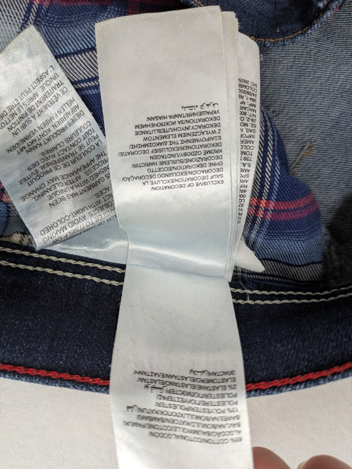 Tommy Hilfiger Denim blue straight jeans with five-pocket design and natural fading details.