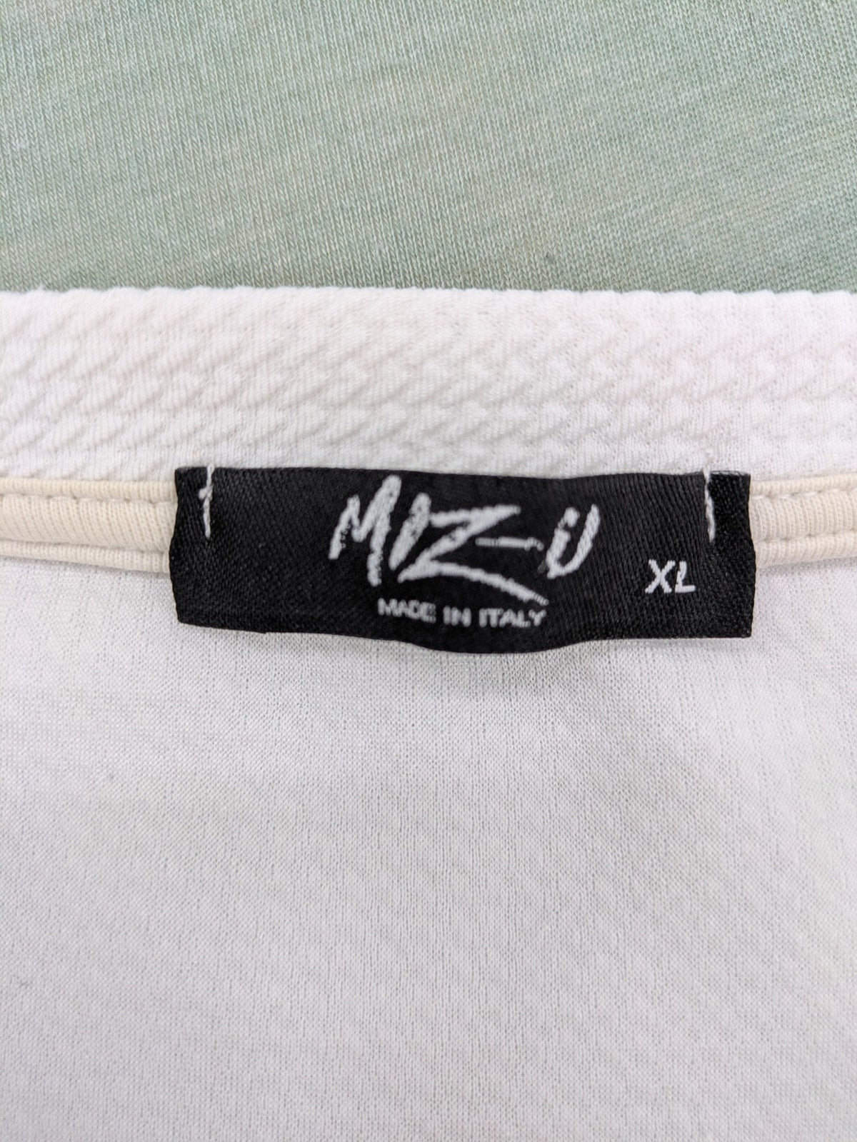 MIZ-U white longline t-shirt with "Street Angels" embroidery and rolled sleeves.