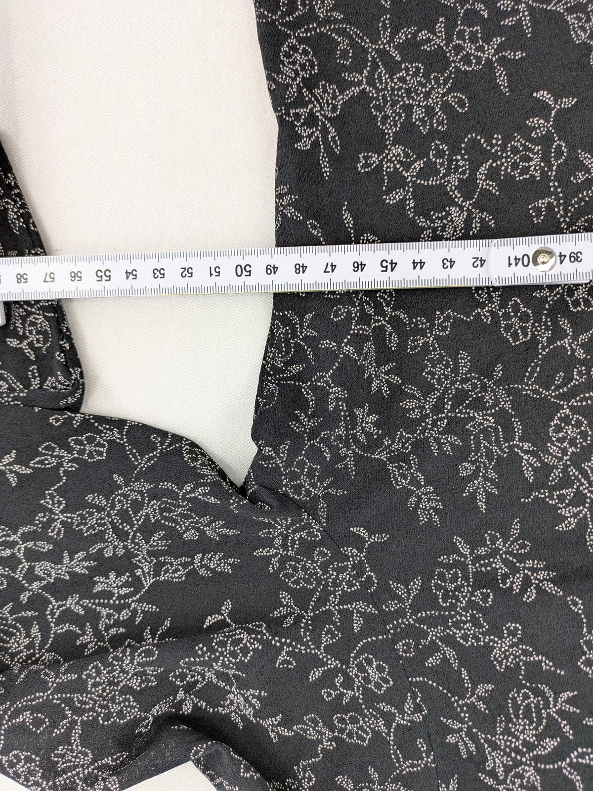 Simply The Best black top with white floral pattern and gathered front detail.