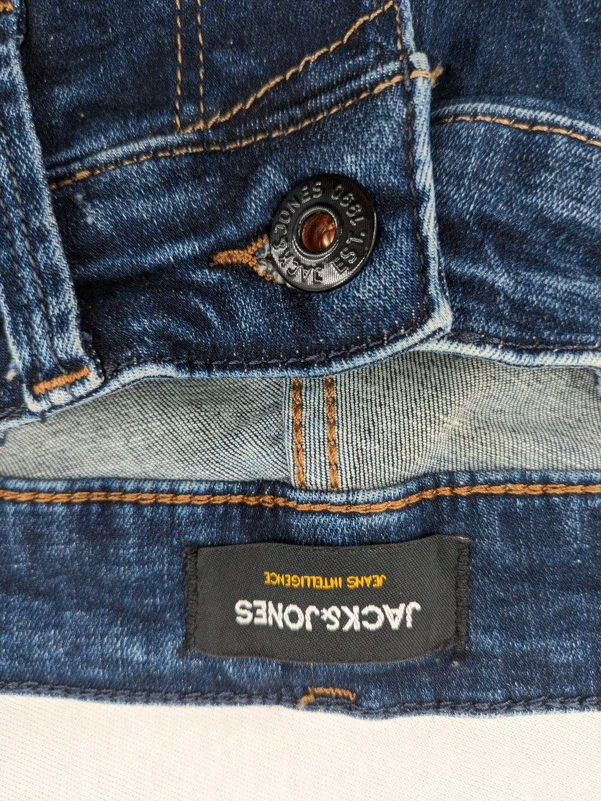 Jack & Jones blue slim fit jeans with faded wash and classic button fly.