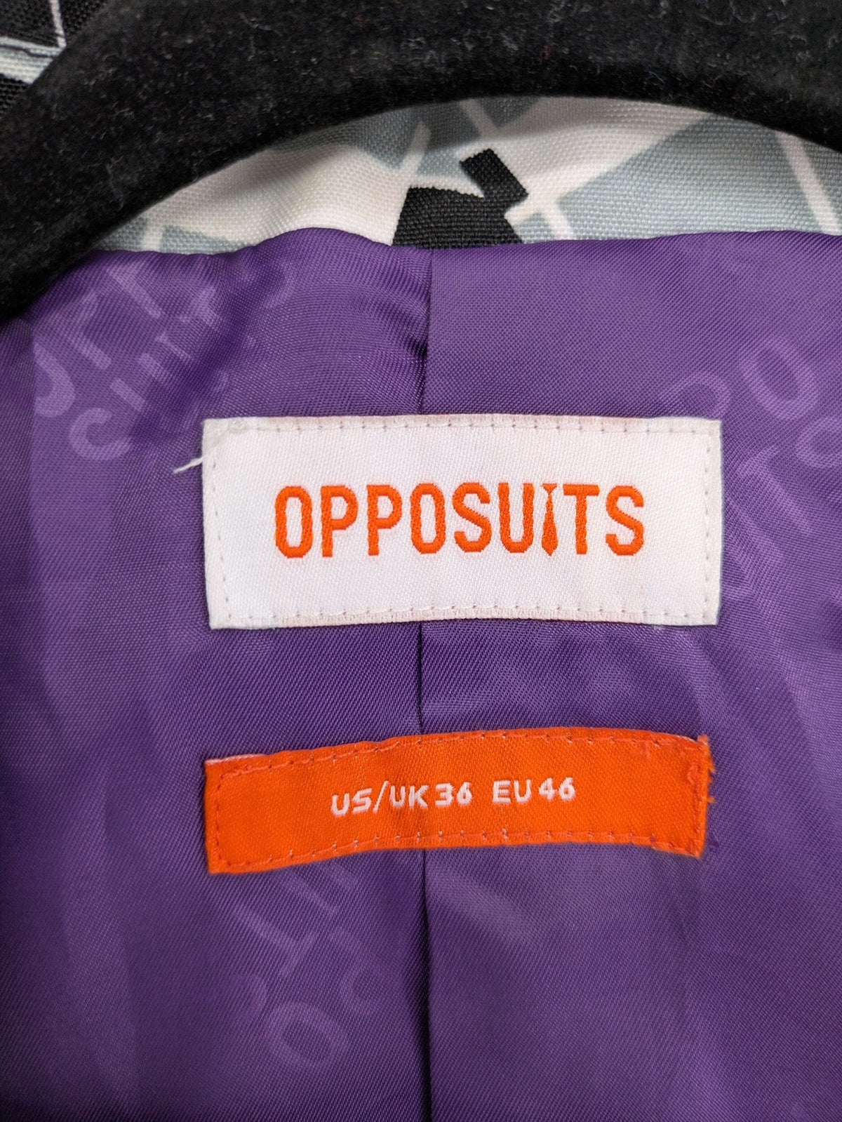 Opposuits blue and green blazer with vibrant geometric pattern and purple satin lining.