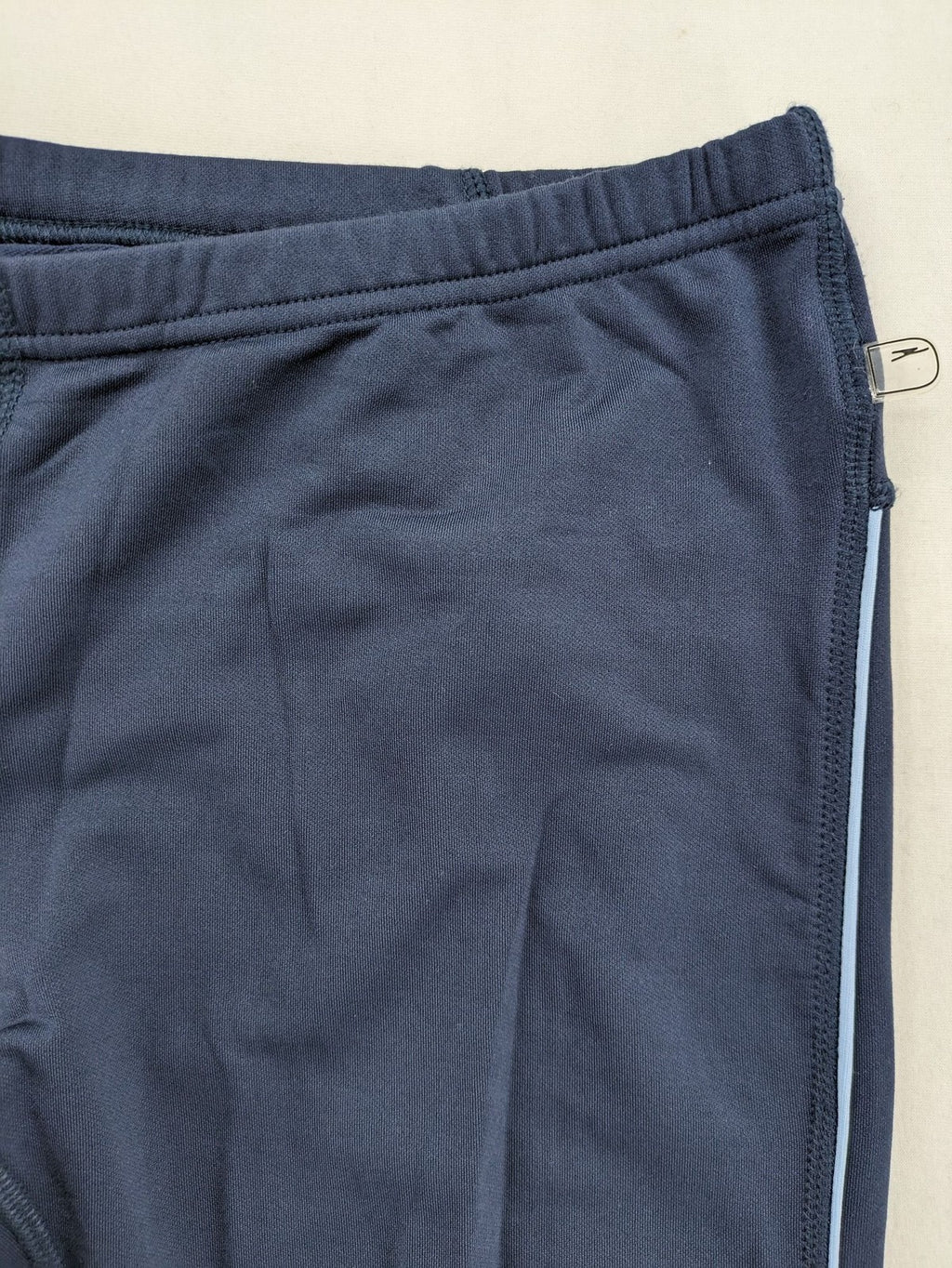 Crane Sports navy running tights with reflective details and zippered ankle openings.