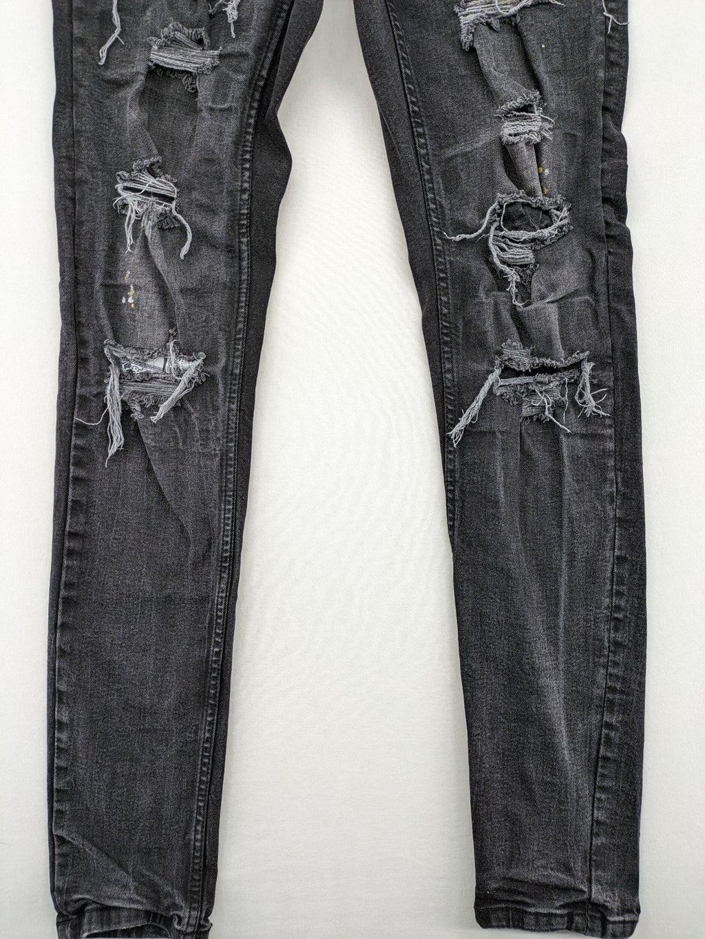 Black Squad skinny fit jeans black distressed ripped design with subtle paint splatter.