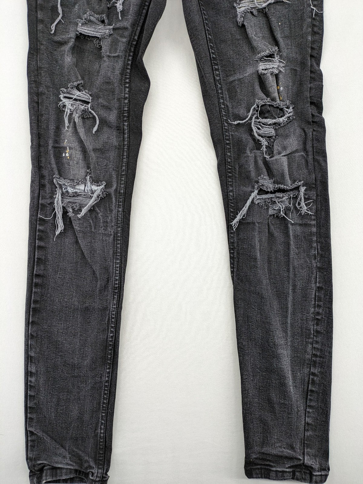Black Squad skinny fit jeans black distressed ripped design with subtle paint splatter.