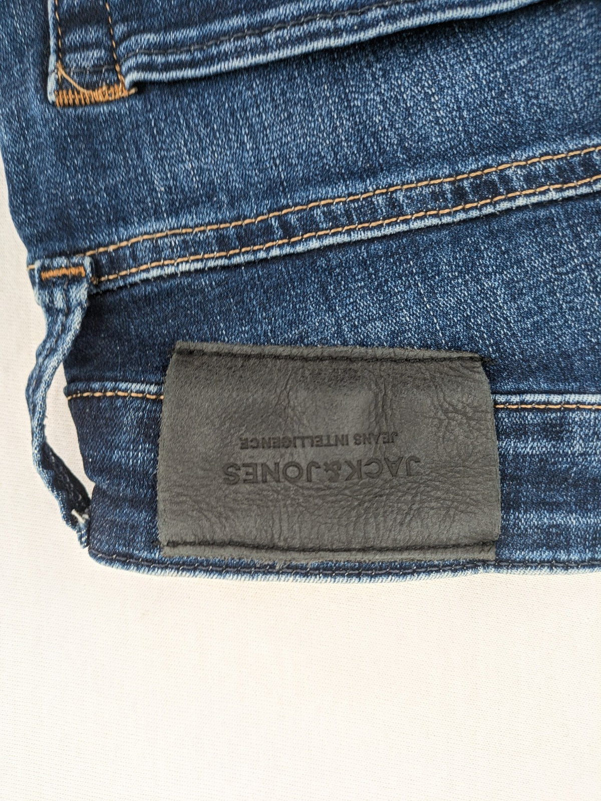 Jack & Jones blue slim fit jeans with faded wash and classic button fly.