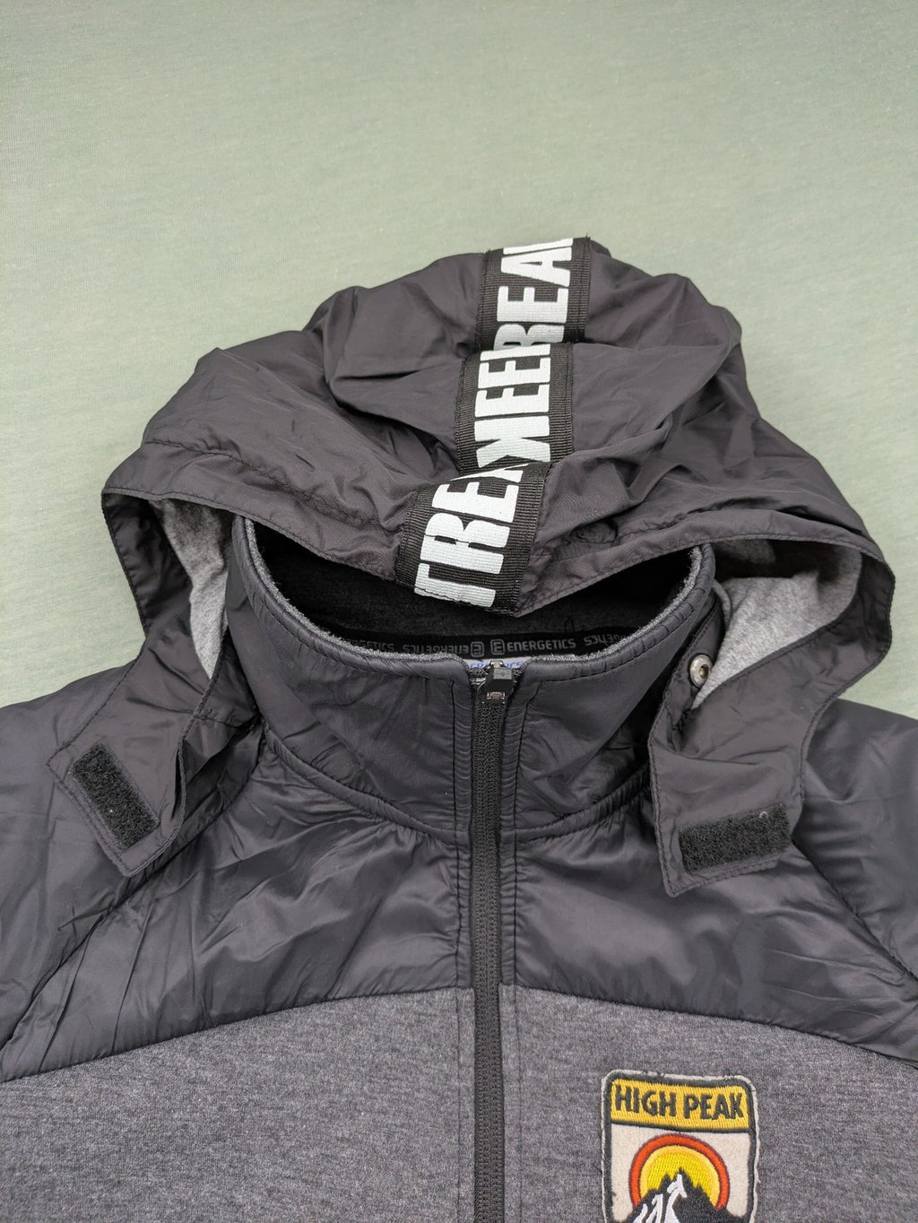 Energetics hybrid jacket black grey with High Peak patch and zip-up design.