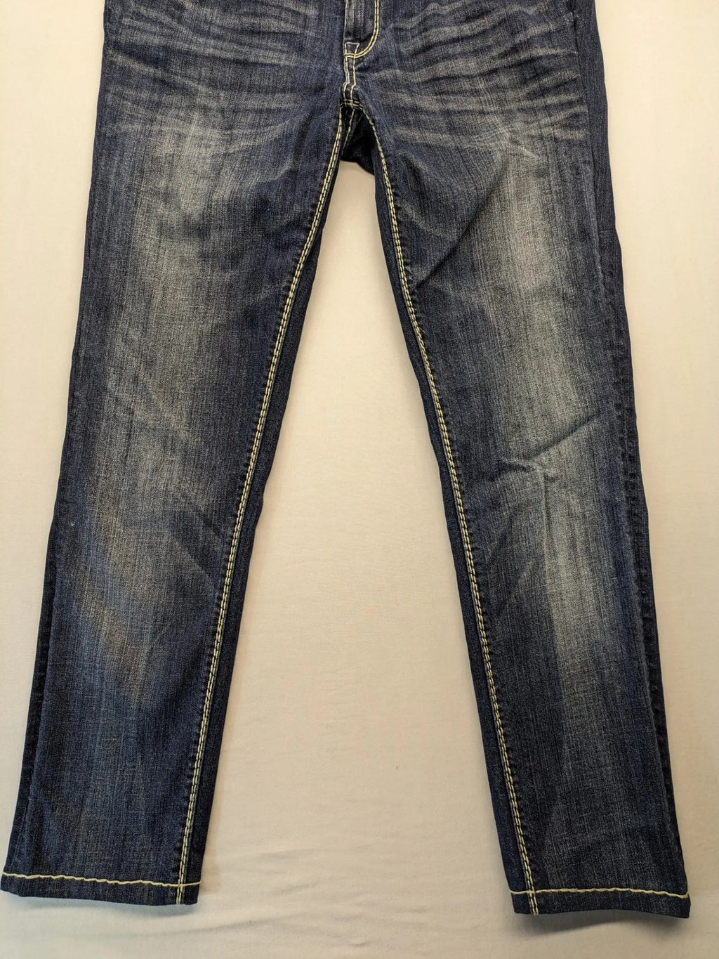 Rhodes blue skinny jeans with decorative studs and intricate embroidery on back pockets.
