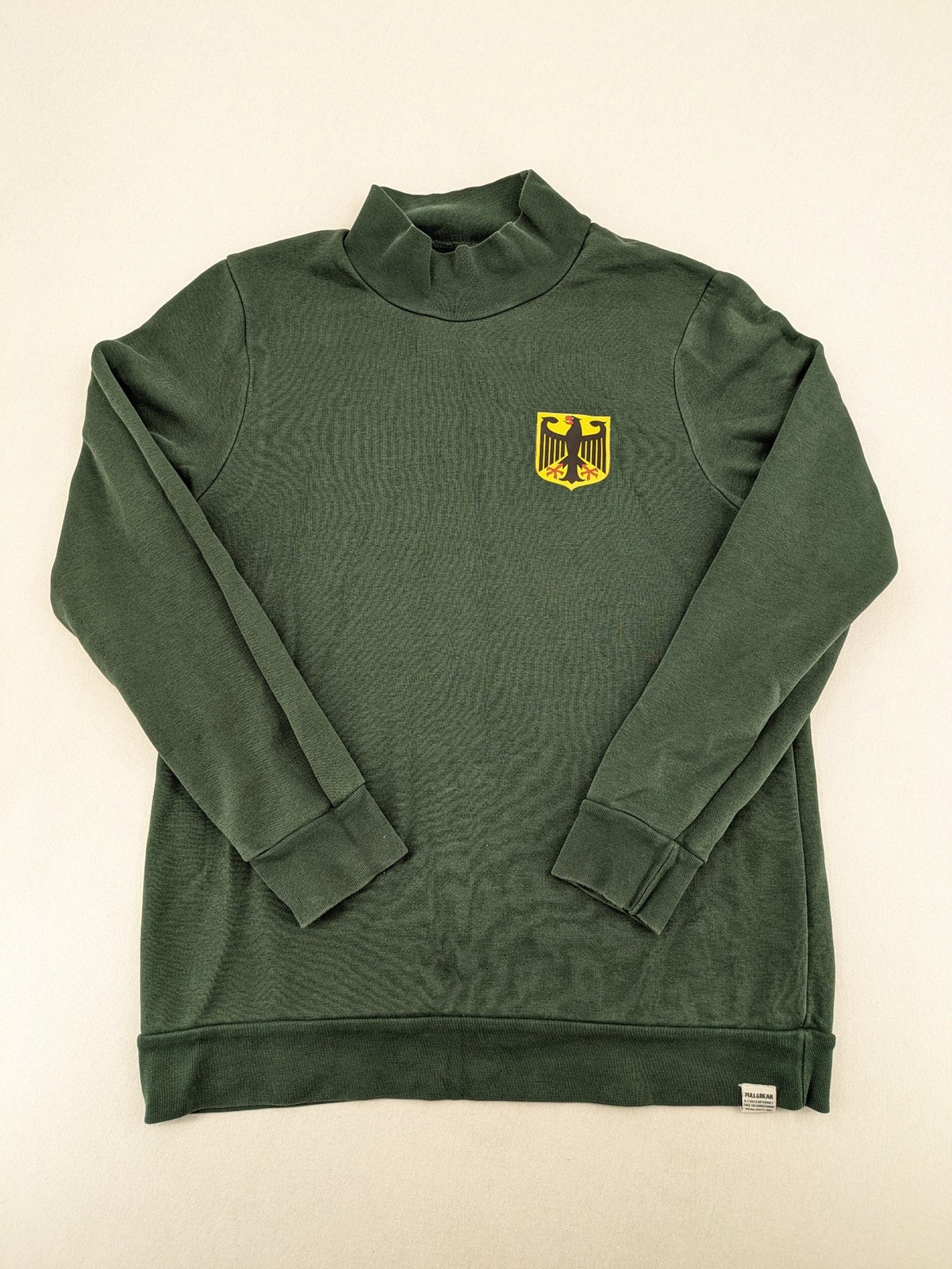 Pull & Bear green sweatshirt with embroidered Germany eagle patch and mock neck.