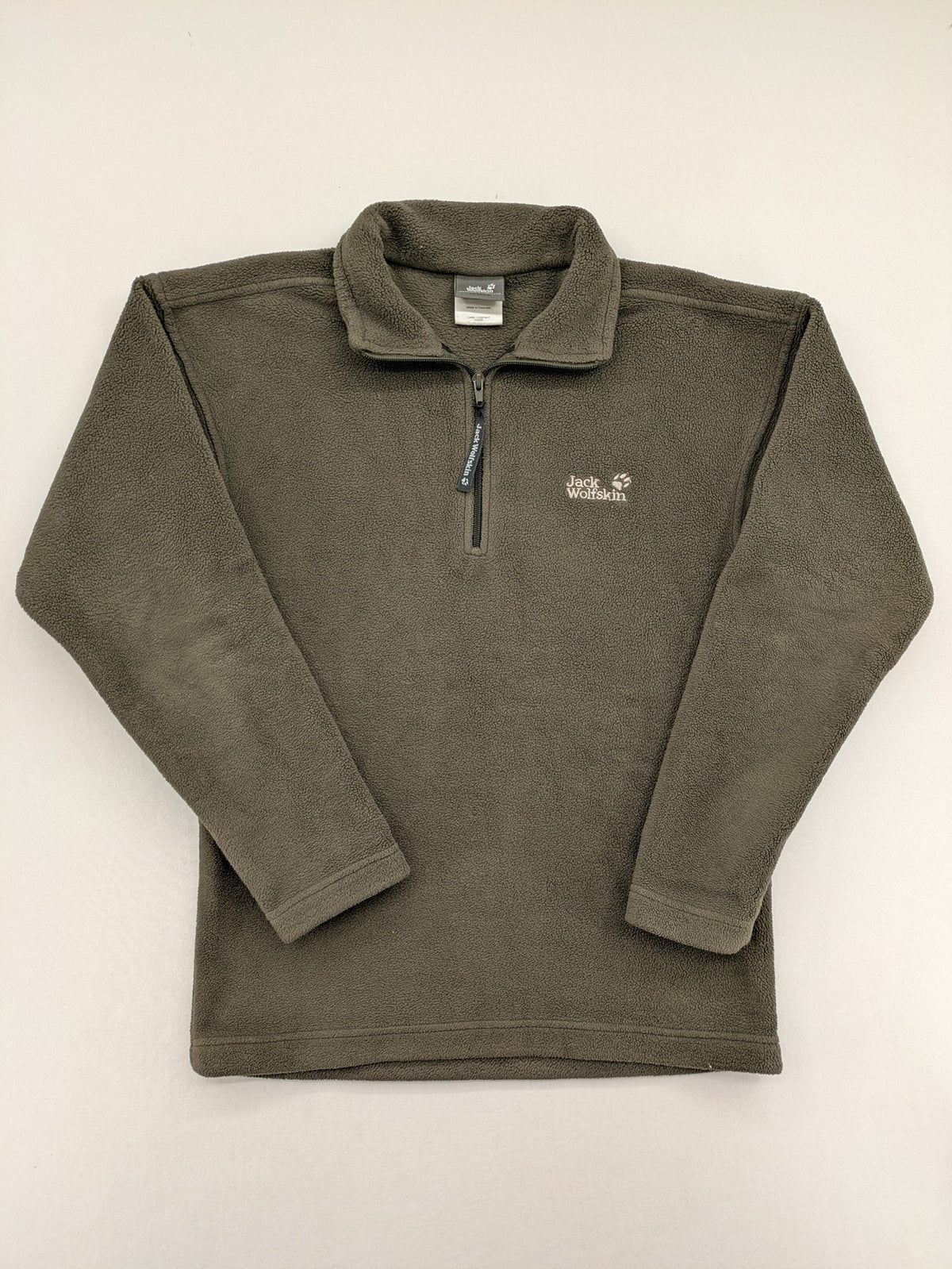 Jack Wolfskin khaki turtle neck jumper with quarter zip and embroidered paw logo.