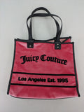 Juicy Couture pink velour handbag with oversized black logo and faux leather straps.