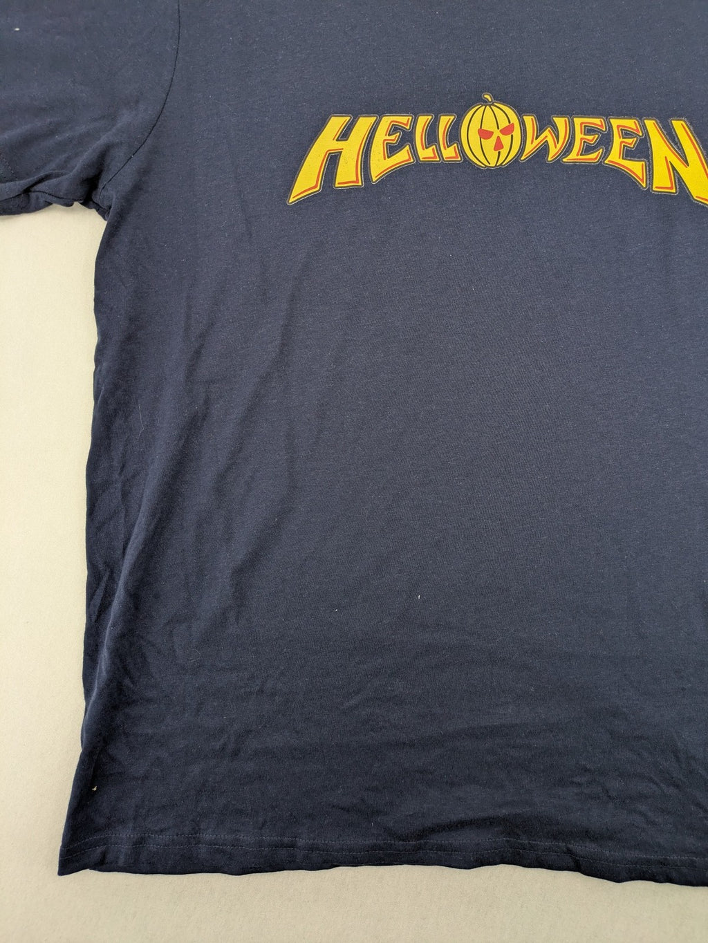 Helloween navy band T-shirt featuring iconic logo and pumpkin graphic, cotton material.