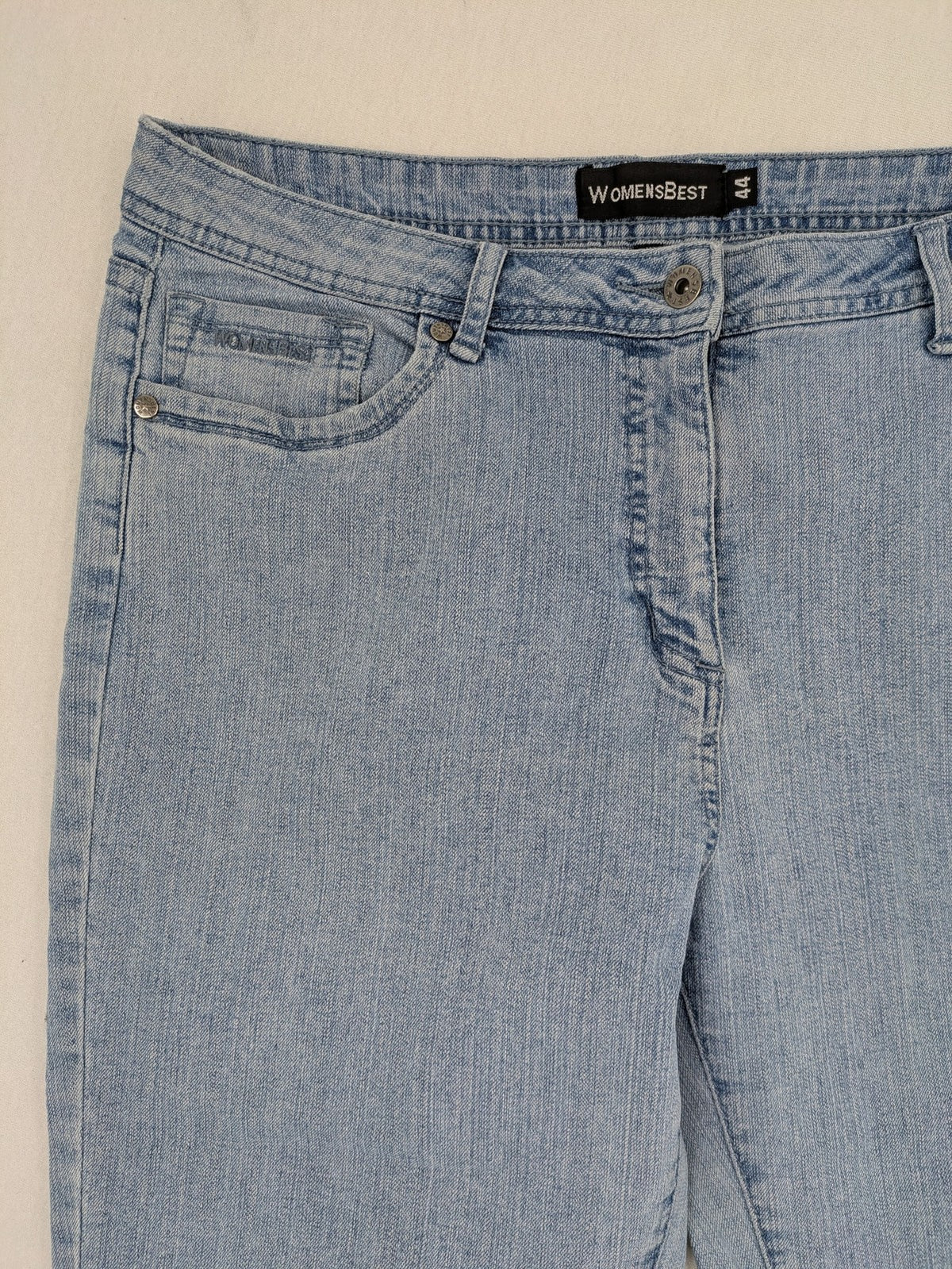 Capri blue straight jeans with 5-pocket design and embroidered details on back pockets.